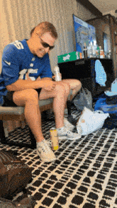 a man wearing a blue jersey with the number 15 on it