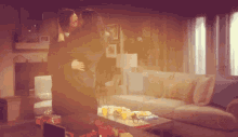 a couple kissing in a living room with a couch and coffee table