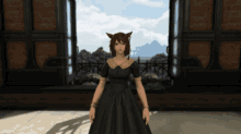 a woman in a black dress with a cat ear stands in front of a window