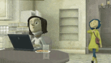 a woman is sitting at a table using a laptop computer