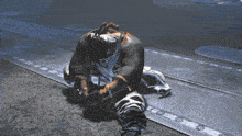 a video game character is kneeling down on the ground with his head down