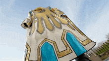a white and gold costume with a blue stripe on the bottom