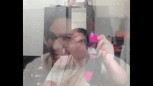 a blurry picture of a man holding a pink object
