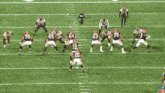 a football game is being played on a field with the word stop on it