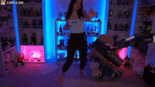 a woman is dancing in front of a microphone in a room with stuffed animals