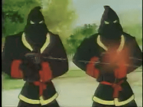 Two hooded figures shoot lasers at two boys in uniform