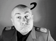 a bald man with a question mark on his head