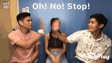 a group of people sitting in front of a blue wall with the words oh no stop written above them