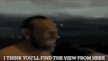 a man is talking into a microphone and says " i think you ll find the view from here "