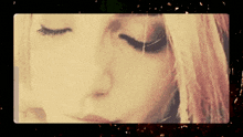 a close up of a woman 's face with the eyes closed