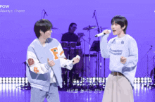 two men singing in front of a microphone with the words pow always i here on the bottom