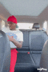 a man in a chicago t-shirt is sitting in the back seat of a car