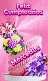a feliz cumpleanos greeting card with flowers on a pink background