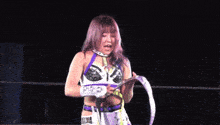 a female wrestler is wearing a belt that says stella