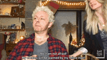 a man in a plaid shirt says no i am not afraid