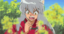 a cartoon character with gray hair and a red shirt is standing in a field of yellow flowers .