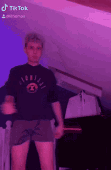 a man wearing shorts and a shirt that says tik tok