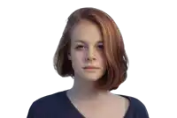 a woman with red hair is wearing a blue shirt and looking at the camera