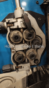 a machine with the words hold on while i think written on it