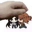 a hand is holding a couple of anime characters .