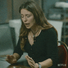 a woman sitting at a table with the words " don 't mind me " written on the bottom