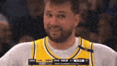 a basketball player wearing a jersey that says espn is smiling