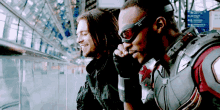 two men in superhero costumes are sitting next to each other