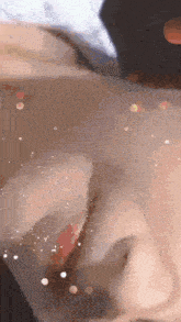 a close up of a person 's face with a blurred background .