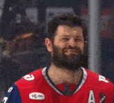 a man with a beard wearing a red and blue jersey with the letter a on it