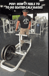 a man wearing a shirt that says marine college classic is doing seated calf raises in a gym