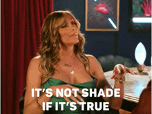a woman sitting at a table with the words it 's not shade if it 's true above her