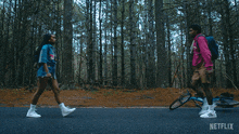 a man and a woman are walking down a road with a netflix logo in the background
