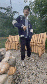 a boy in a blue jacket with the letter l on it