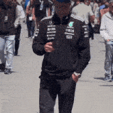 a man wearing a jacket that says ubs and ineos