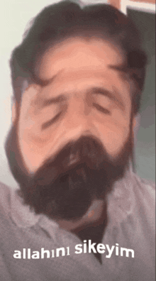 a man with a beard has his eyes closed and the words allahini sikeyim written on the bottom