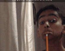 a man is holding a pencil in his mouth while looking at himself in the mirror
