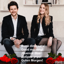 a man and a woman are sitting on a couch with roses around them