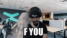 a man wearing headphones and a hat that says blizzard says " f you "