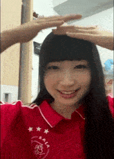 a woman wearing a red shirt with a heart and stars on it