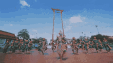 a group of people are dancing in front of a large wooden gallows