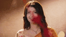 a close up of a woman 's face with red paint on it .