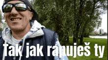 a man wearing sunglasses and a hat is smiling with the words tak jak rapujes ty below him