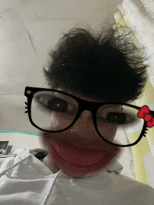 a person wearing glasses and a hello kitty bow