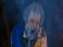 a man with a beard is covered in ice and has his mouth wide open