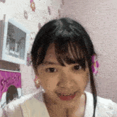 a girl is smiling in front of a sign that says ' shonichi ' on it