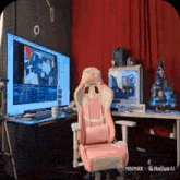 a pink chair sits in front of a monitor and a sign that says " they comas "
