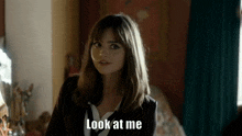 a woman says " look at me " in a room