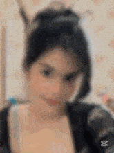 a blurry picture of a woman 's face with a x in the corner .