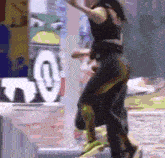 a blurry image of a woman dancing in front of a sign that says t.v.