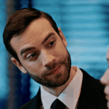 a man with a beard in a suit and tie